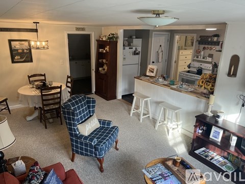 A living room with a blue chair and a coffee table.