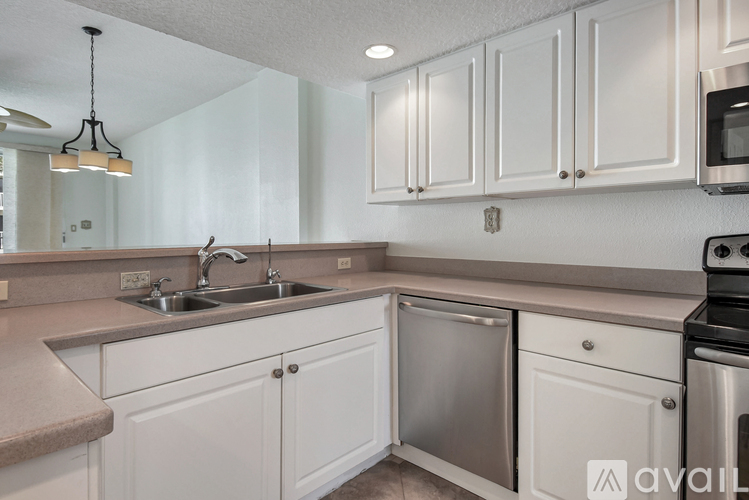 A kitchen with white cabinets and stainless steel appliances.