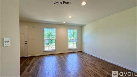 A living room with a door and a window.