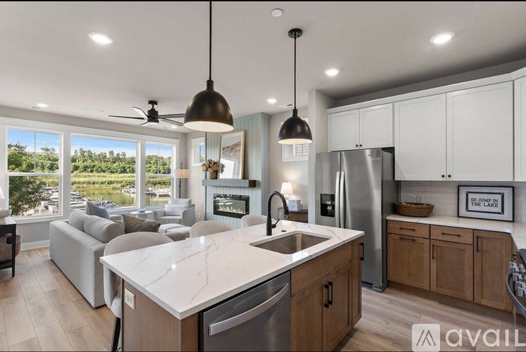 A modern kitchen with a large island and a view of the outdoors.