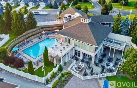 A large house with a pool and a hot tub.