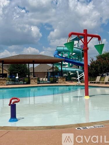 A pool with a slide and a water slide.