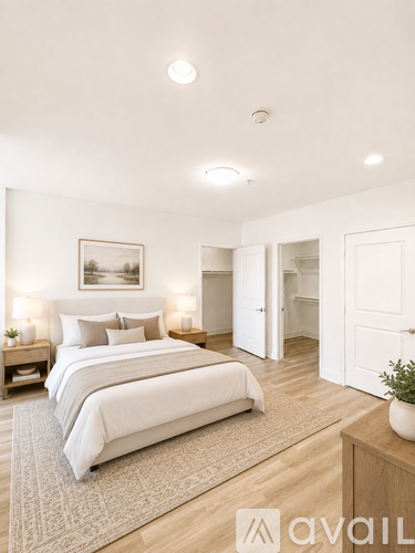 A bedroom with a large bed and a painting on the wall.