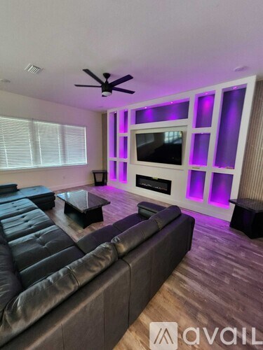 A living room with a grey couch and a television.