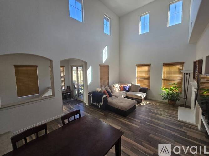 A living room with a couch, chairs, and a coffee table.