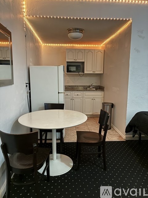A small kitchen with a table and chairs.