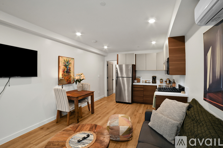 A modern kitchen with a dining table and chairs.
