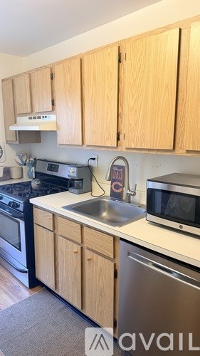 A kitchen with wooden cabinets and stainless steel appliances.