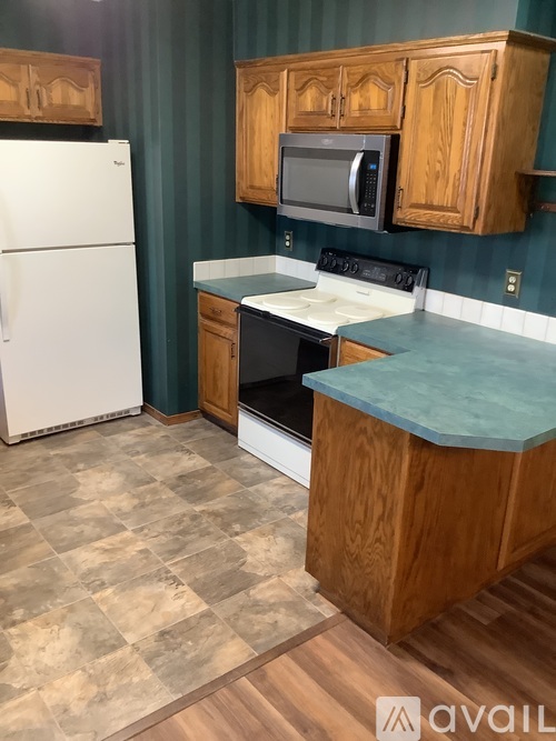 A kitchen with a white refrigerator and a white oven.
