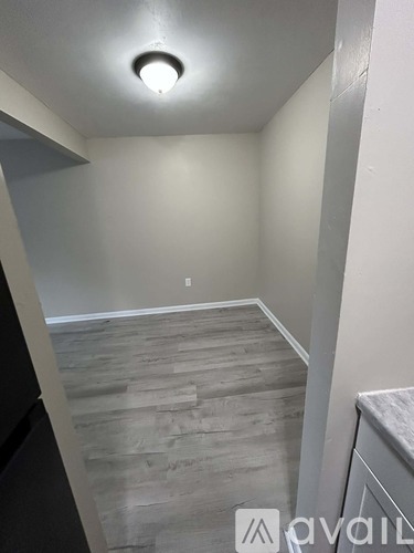 A room with a wooden floor and a light on the ceiling.