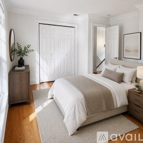 A bedroom with a large bed and a wooden dresser.