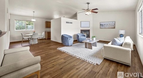 A living room with a white couch and a blue chair.