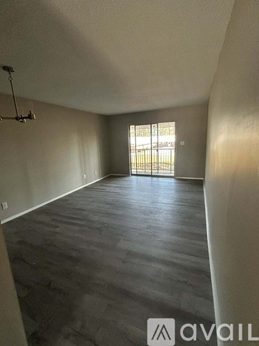 A room with a slanted ceiling and a door leading outside.