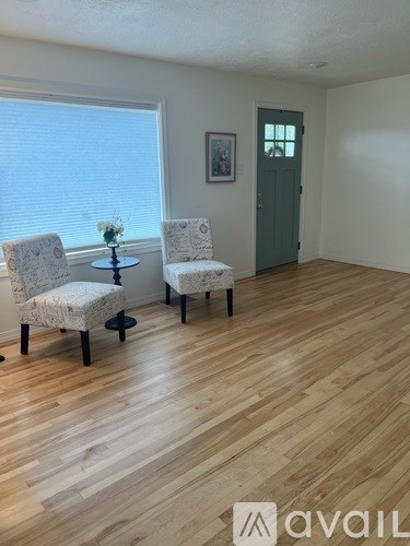 Two chairs are placed in a room with wooden flooring.