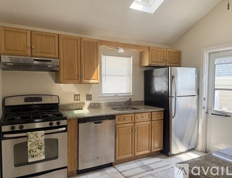 A kitchen with wooden cabinets and stainless steel appliances.