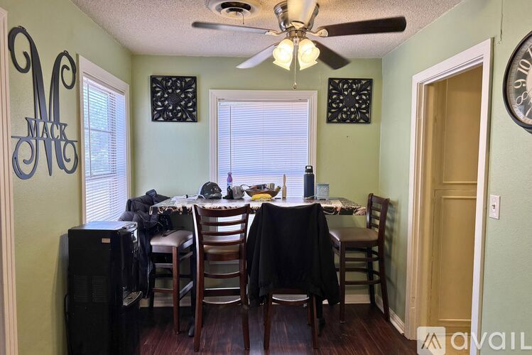 A dining room with a table set for a meal.