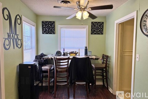 A dining room with a table set for a meal.