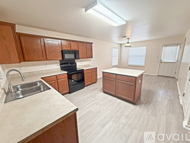 A kitchen with wooden cabinets and a black oven.