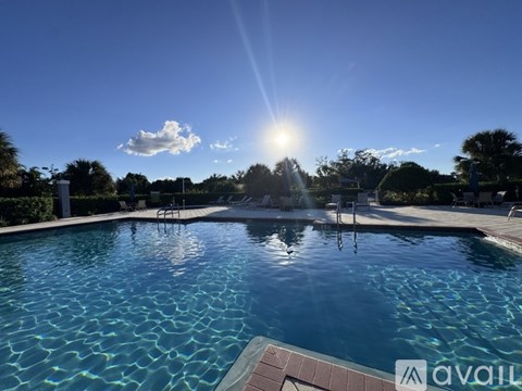 A pool with sunlight reflecting off the water.