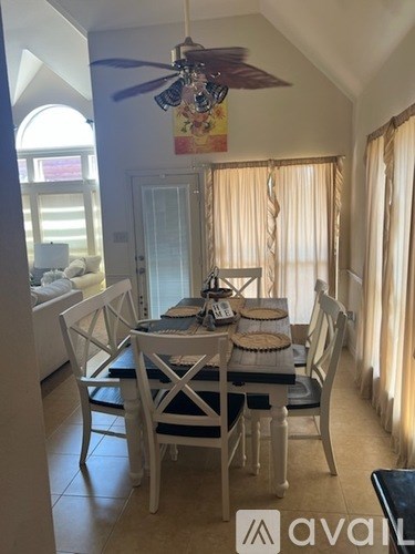 A dining room with a table set for four.