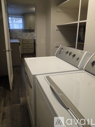 A white washing machine in a laundry room.