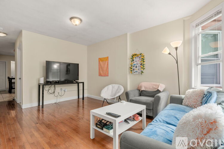A living room with a white coffee table and a grey couch.