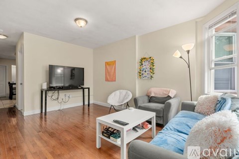 A living room with a white coffee table and a grey couch.