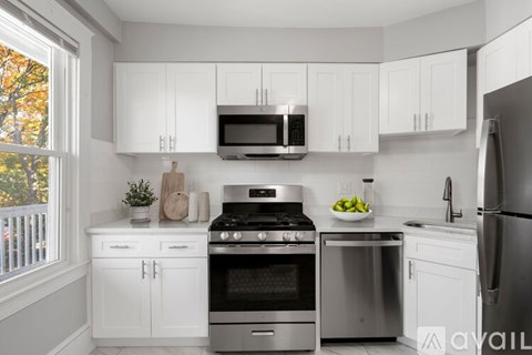 A kitchen with white cabinets and stainless steel appliances.