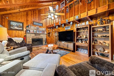A cozy living room with a fireplace and a television.