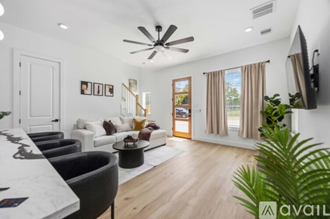 A living room with a white ceiling and a ceiling fan.