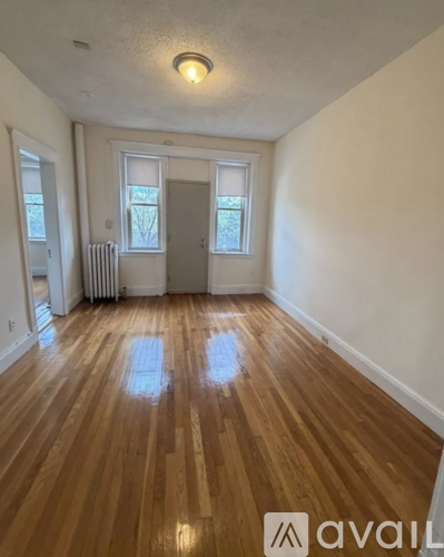 A room with wooden floors and a white door.