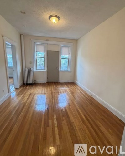 A room with wooden floors and a white door.