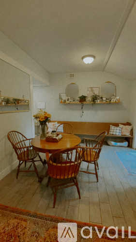 A dining room with a table and chairs.