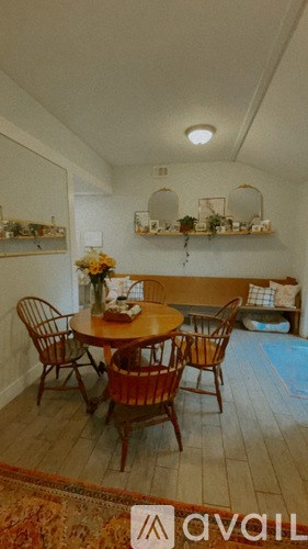A dining room with a table and chairs.