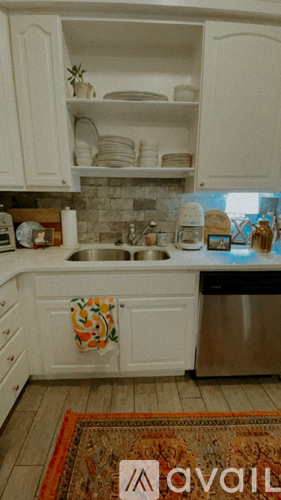 A kitchen with a sink and a dishwasher.