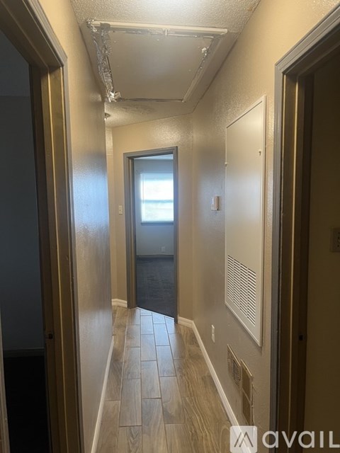 A long hallway with a door at the end.