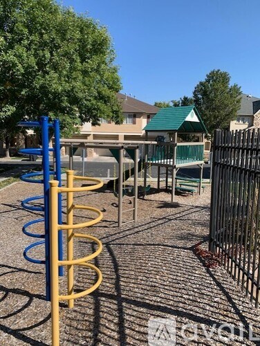 A playground with a blue and yellow slide.