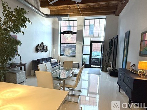A modern living room with a glass table and chairs.