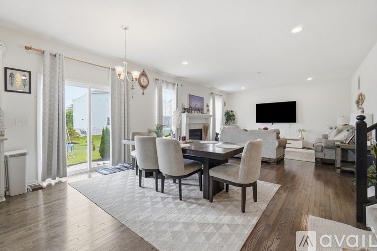 A modern dining room with a large table and chairs.