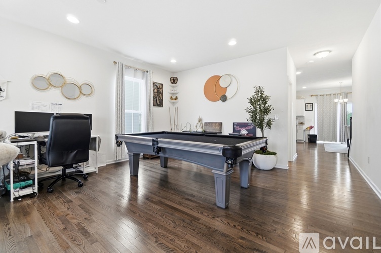 A room with a pool table and a television.