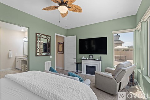 A bedroom with a large bed and a fireplace.