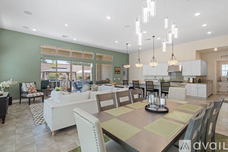 A modern kitchen with a dining table set for six.