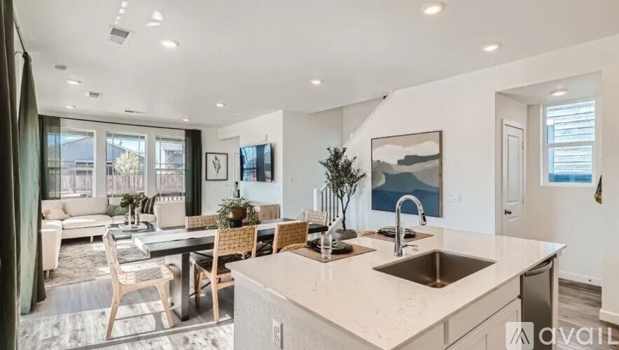 A modern kitchen with a dining table and chairs.