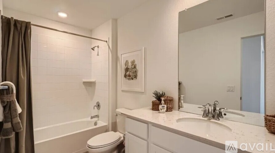 A bathroom with a toilet, sink, and bathtub.