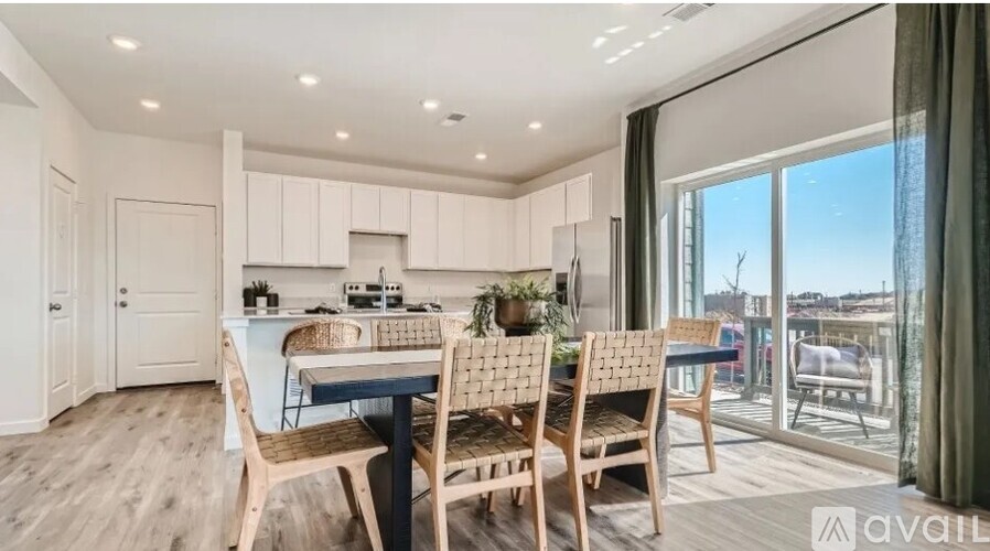 A modern kitchen with a dining table and chairs.