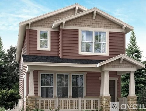 A two-story house with a brown exterior and white trim.