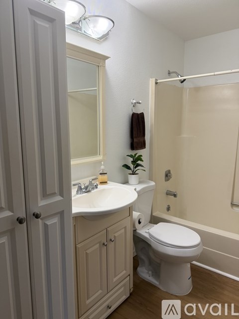 A white sink and toilet in a bathroom.
