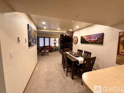 A dining room with a table set for six.