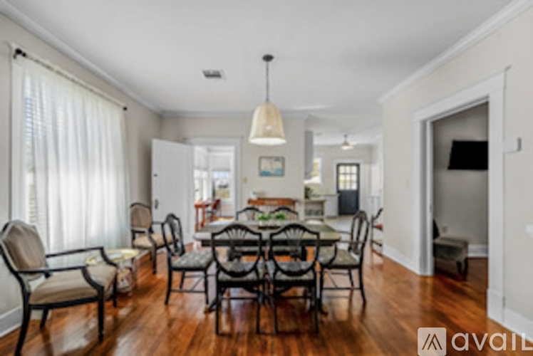 A dining room with a table set for six.