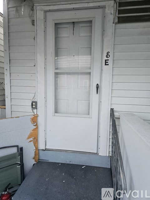 A white door with a glass window and a black handle.